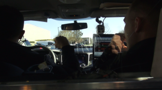 Officer Curry Hall rides along with another Burlington Police Department officer during his training period.