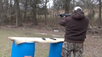 Elon self defense instructor Jason Thomas fires an AK-47 at his home range (Andrew Feather/ELN)