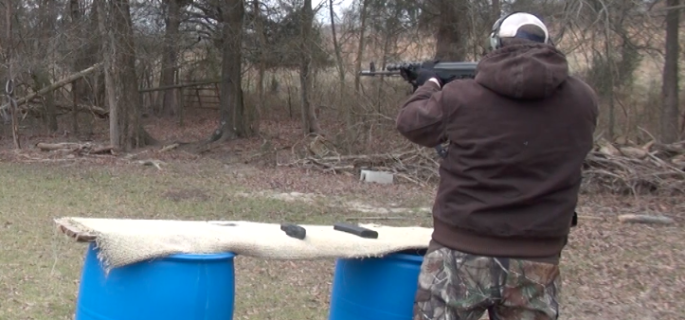 Elon self defense instructor Jason Thomas fires an AK-47 at his home range (Andrew Feather/ELN)